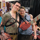 A cosplayer dressed as Ash poses with an admirer at a horror convention.